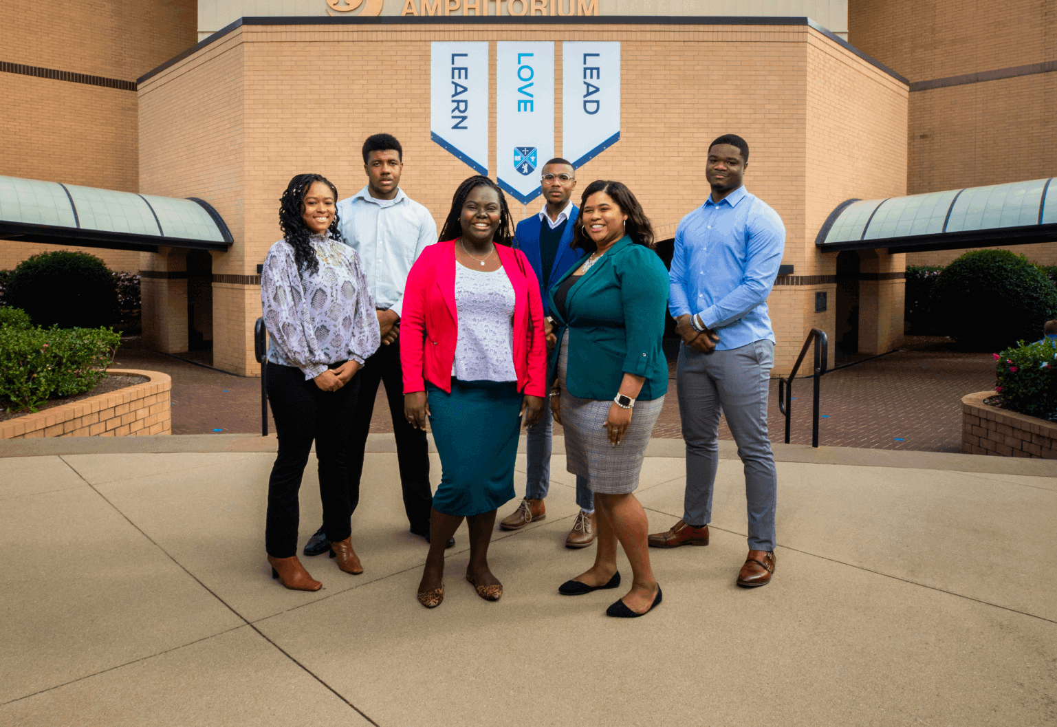 Group of minority students standing outside the auditorium
